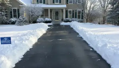 Clean driveway after professional snow removal by Chop Chop Landscaping in Green Bay, WI